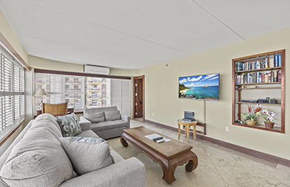 Living Room Area with Large TV and Split AC       